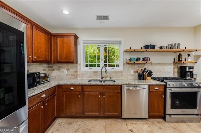 72 Griggs St SW, Marietta, GA 30064 - kitchen featuring appliances with stainless steel finishes, tasteful backsplash, light stone countertops, open shelves, and recessed lighting