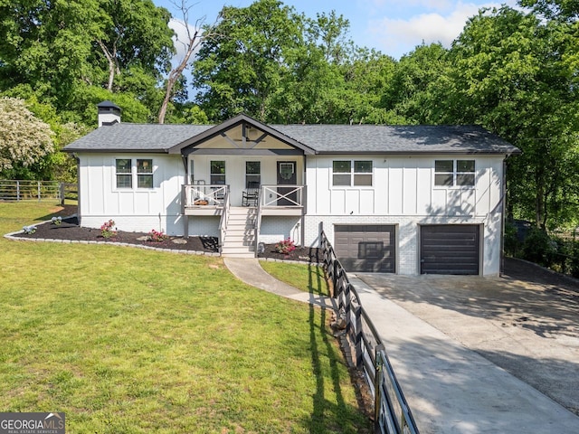 369 Arnold Mill Rd, Woodstock, GA 30188 - ranch-style home with an attached garage, board and batten siding, a chimney, concrete driveway, and covered porch