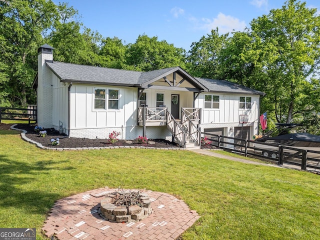 369 Arnold Mill Rd, Woodstock, GA 30188 - view of front facade with an attached garage, board and batten siding, a chimney, and a porch