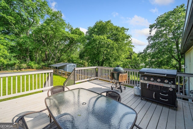 369 Arnold Mill Rd, Woodstock, GA 30188 - wooden deck with a yard, an outbuilding, outdoor dining area, and a storage unit