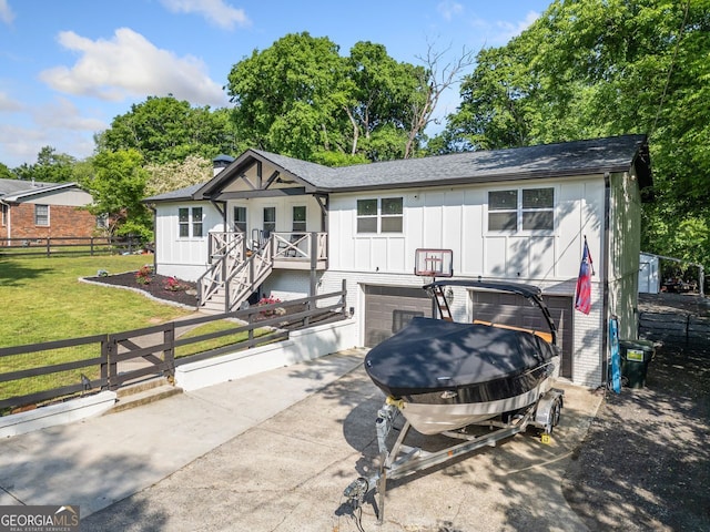 369 Arnold Mill Rd, Woodstock, GA 30188 - exterior space with board and batten siding, fence private yard, a front lawn, concrete driveway, and an attached garage