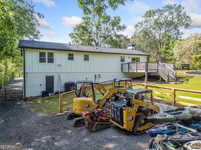 369 Arnold Mill Rd, Woodstock, GA 30188 - back of house featuring a wooden deck, fence, a chimney, brick siding, and board and batten siding