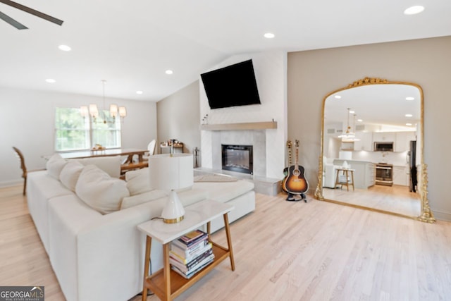 369 Arnold Mill Rd, Woodstock, GA 30188 - living room with ceiling fan, a high end fireplace, vaulted ceiling, light wood finished floors, and recessed lighting