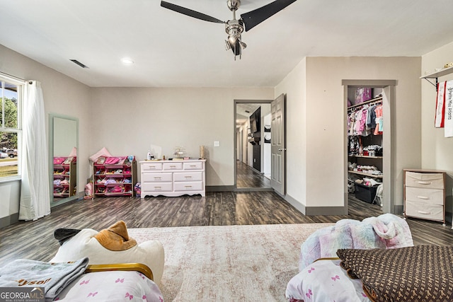 bedroom with wood finished floors, baseboards, and ceiling fan