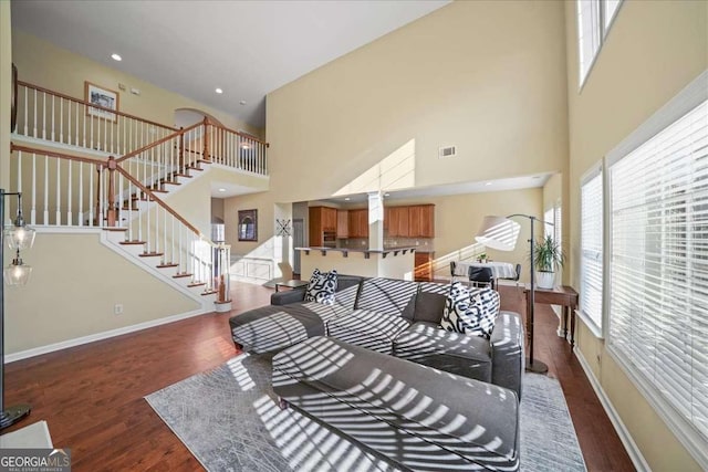 3125 Crooked Stick Dr, Cumming, GA 30041 - living room with baseboards, a high ceiling, stairs, and dark wood-style flooring