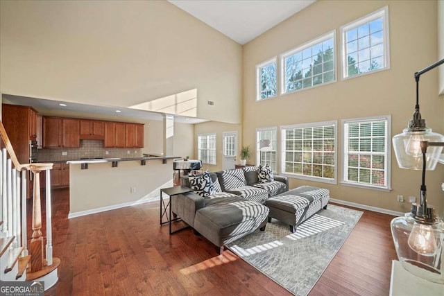 3125 Crooked Stick Dr, Cumming, GA 30041 - living area with dark wood-type flooring, baseboards, visible vents, and high vaulted ceiling
