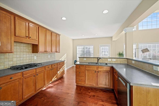 3125 Crooked Stick Dr, Cumming, GA 30041 - kitchen with dark countertops, a sink, decorative backsplash, stainless steel appliances, and dark wood-type flooring