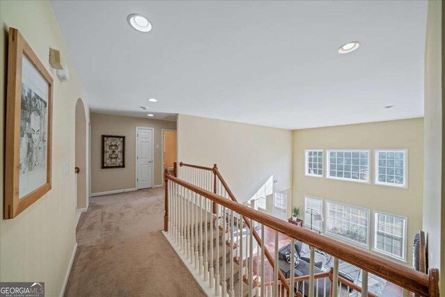 3125 Crooked Stick Dr, Cumming, GA 30041 - hallway with an upstairs landing, arched walkways, light carpet, baseboards, and recessed lighting