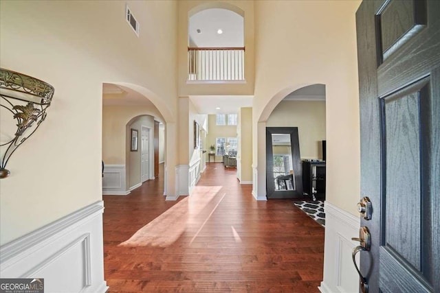3125 Crooked Stick Dr, Cumming, GA 30041 - entryway with arched walkways, dark wood finished floors, visible vents, and a towering ceiling