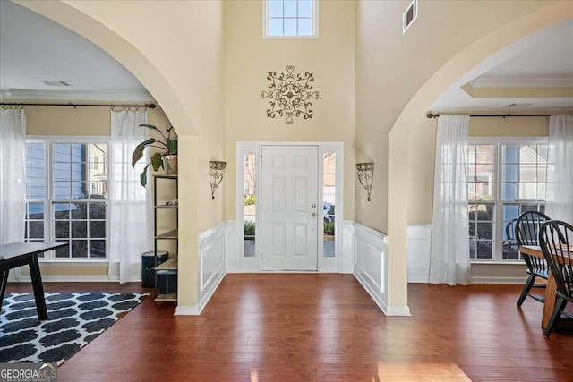 3125 Crooked Stick Dr, Cumming, GA 30041 - foyer entrance featuring wood-type flooring, a decorative wall, wainscoting, and visible vents