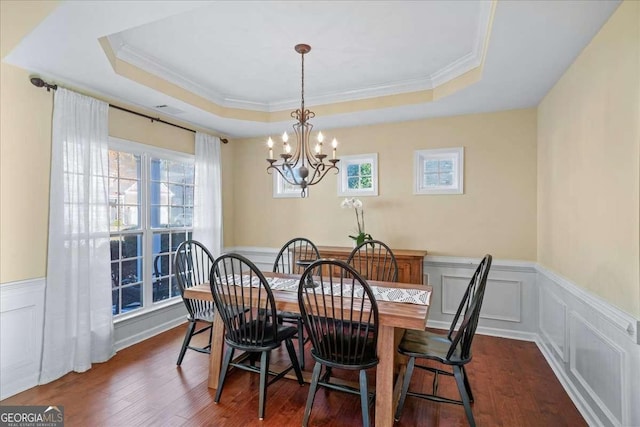3125 Crooked Stick Dr, Cumming, GA 30041 - dining area featuring a wainscoted wall, an inviting chandelier, a raised ceiling, ornamental molding, and dark wood-style flooring