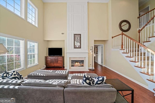 3125 Crooked Stick Dr, Cumming, GA 30041 - living area featuring wood finished floors, a high ceiling, and stairway