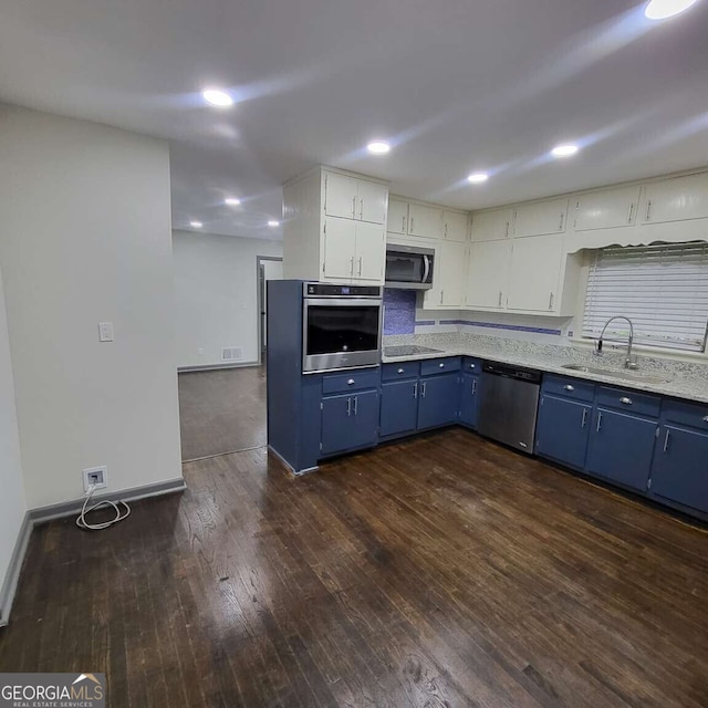 2704 Terratim Ln, Decatur, GA 30034 - kitchen with appliances with stainless steel finishes, blue cabinets, a sink, dark wood-style floors, and baseboards