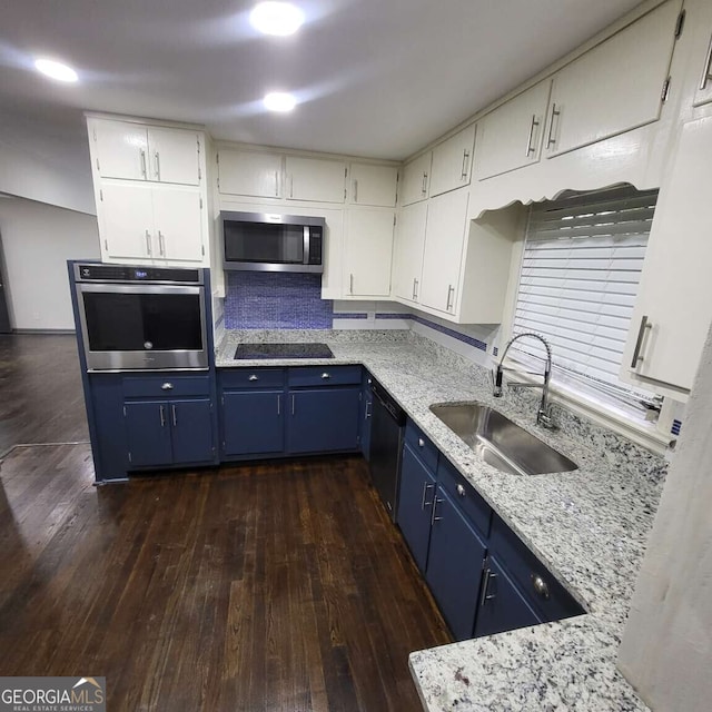 2704 Terratim Ln, Decatur, GA 30034 - kitchen with appliances with stainless steel finishes, a sink, blue cabinetry, dark wood-type flooring, and light stone counters