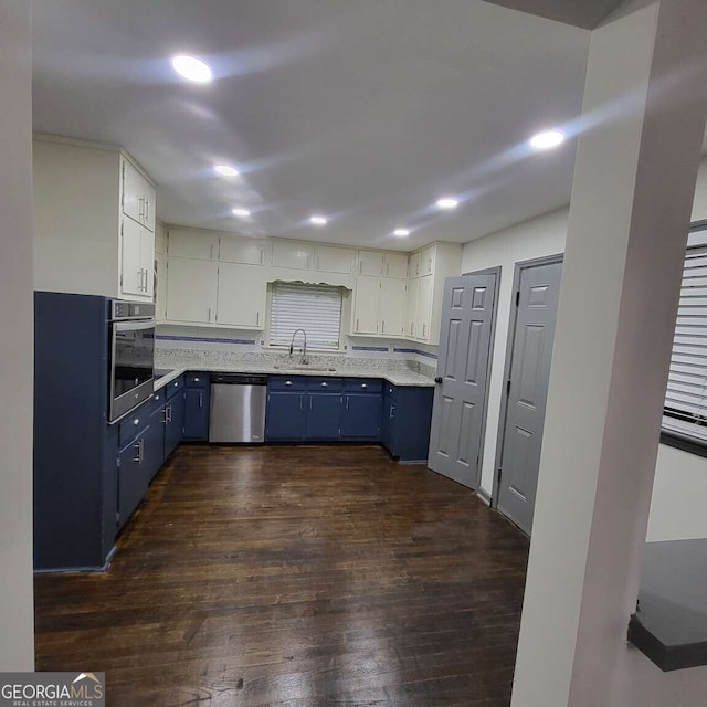 2704 Terratim Ln, Decatur, GA 30034 - kitchen with blue cabinets, appliances with stainless steel finishes, a sink, dark wood finished floors, and recessed lighting