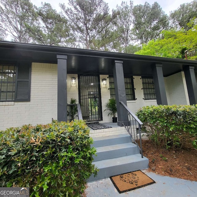 2704 Terratim Ln, Decatur, GA 30034 - doorway to property with brick siding and covered porch