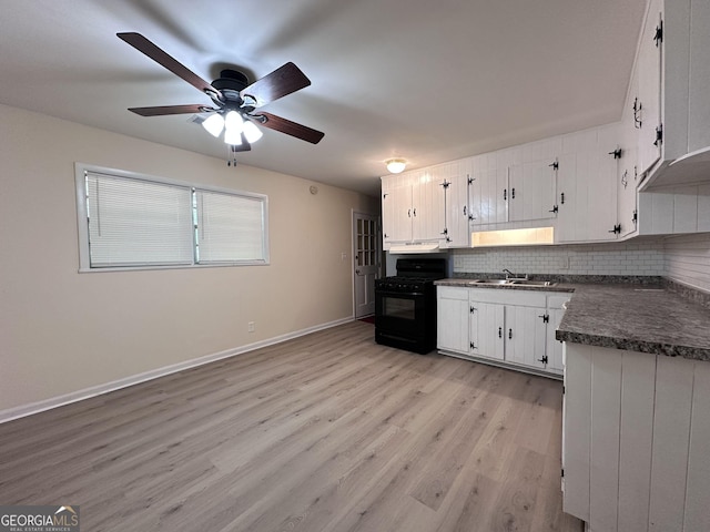 7336 Howard Cir, Jonesboro, GA 30236 - kitchen featuring backsplash, dark countertops, a ceiling fan, a sink, and black range with gas cooktop