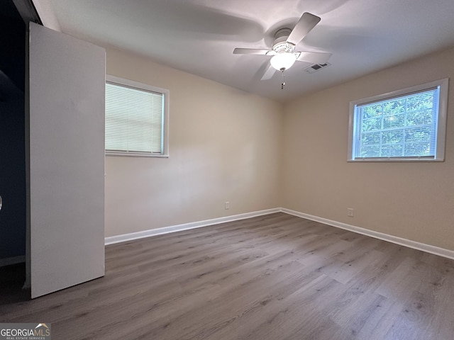 7336 Howard Cir, Jonesboro, GA 30236 - empty room with wood finished floors, visible vents, a ceiling fan, and baseboards