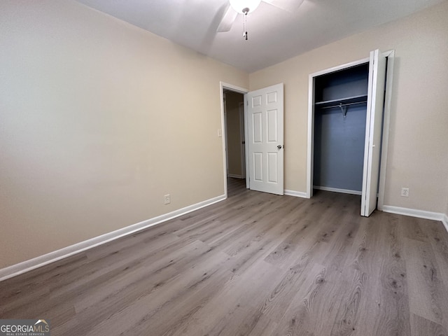 7336 Howard Cir, Jonesboro, GA 30236 - unfurnished bedroom featuring baseboards, a ceiling fan, wood finished floors, and a closet