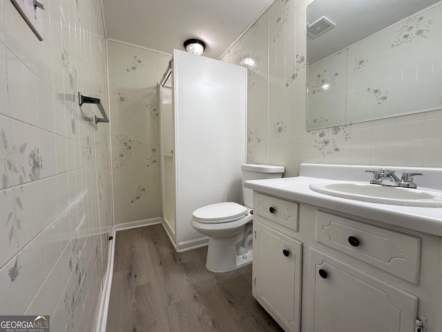 7336 Howard Cir, Jonesboro, GA 30236 - full bathroom with toilet, visible vents, wood finished floors, a shower stall, and vanity