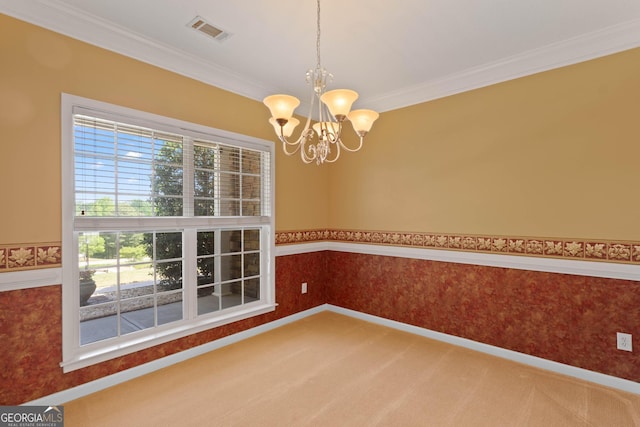carpeted empty room with visible vents, ornamental molding, baseboards, and a notable chandelier