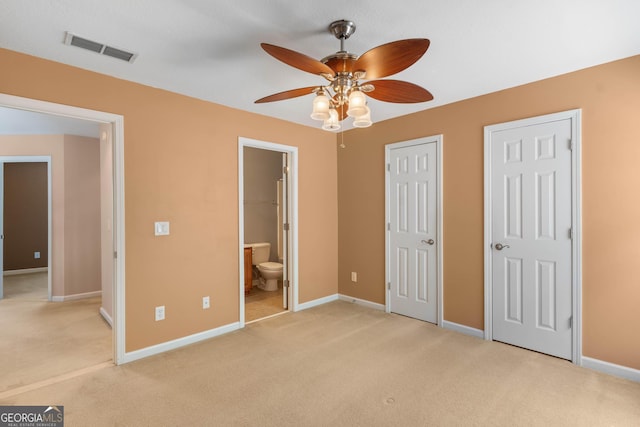 unfurnished bedroom with light colored carpet, baseboards, connected bathroom, and visible vents