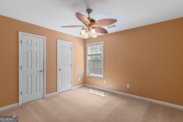 unfurnished bedroom featuring visible vents, baseboards, and carpet floors