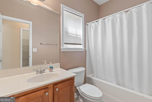 full bath featuring vanity, shower / bathtub combination with curtain, and toilet