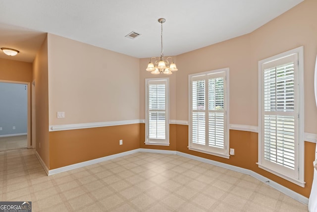 unfurnished dining area featuring baseboards, visible vents, and a notable chandelier
