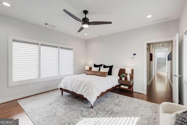 bedroom with recessed lighting, wood finished floors, visible vents, and baseboards