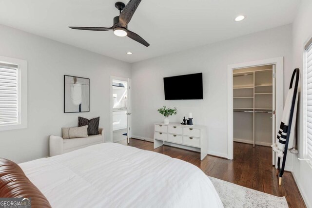 bedroom with wood finished floors, a spacious closet, recessed lighting, and a closet