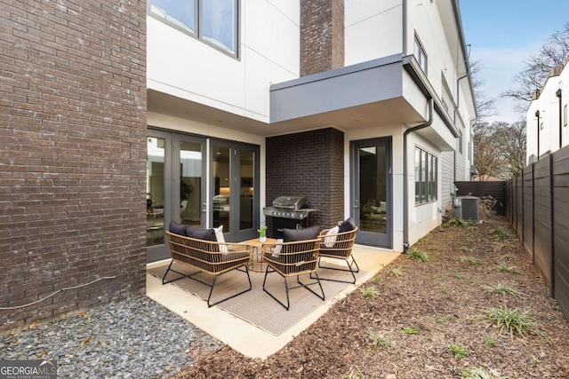 view of patio with a fenced backyard, an outdoor living space, central AC, and area for grilling