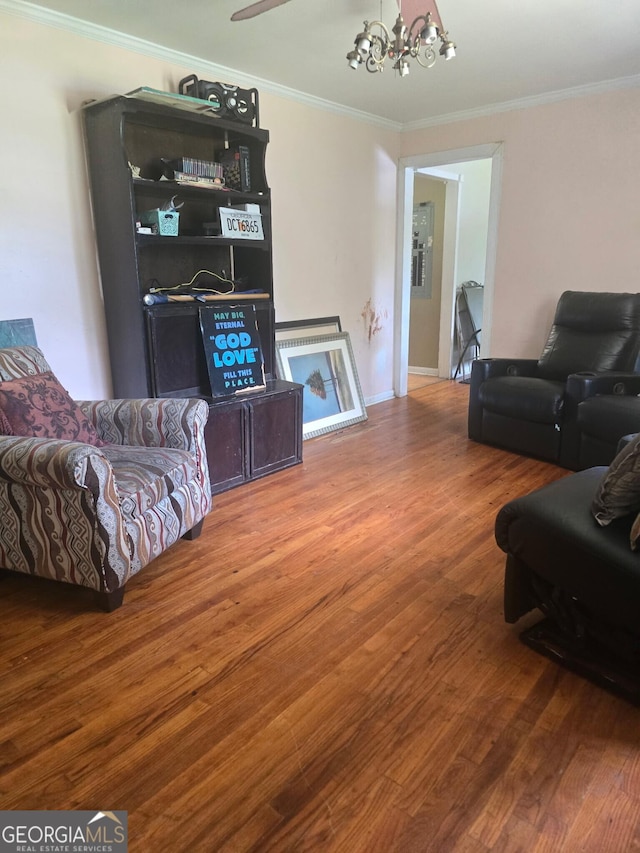 100 Brookwood Dr, Warner Robins, GA 31088 - living area featuring wood finished floors, a chandelier, and ornamental molding