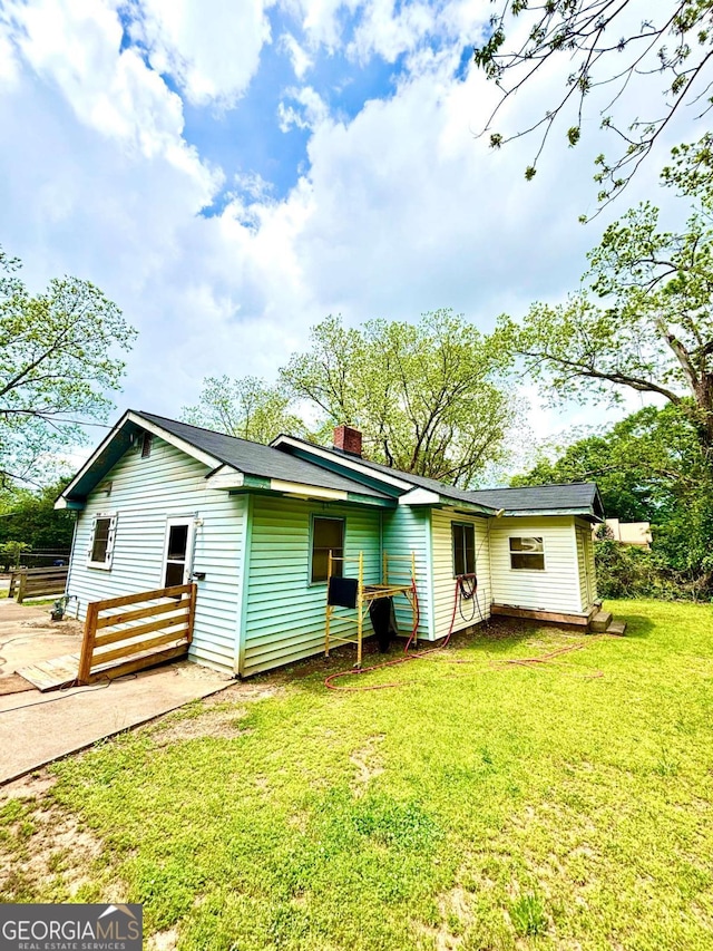 165 Vine St, Athens, GA 30601 - rear view of house with a chimney and a yard