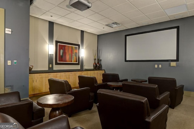 home theater featuring a paneled ceiling, visible vents, carpet flooring, and baseboards