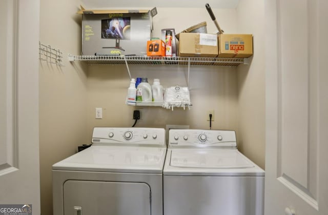 washroom featuring washing machine and dryer and laundry area