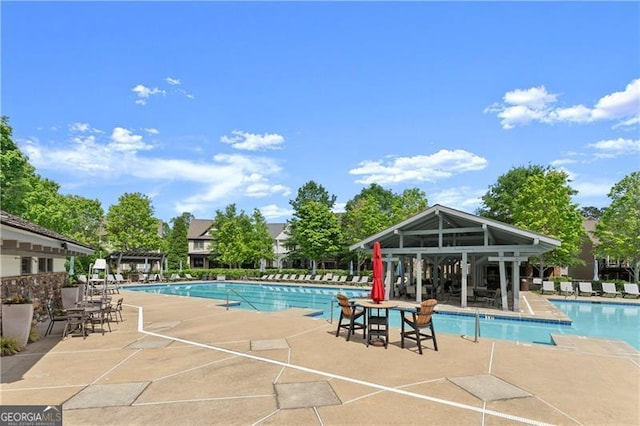 pool with a patio and a gazebo
