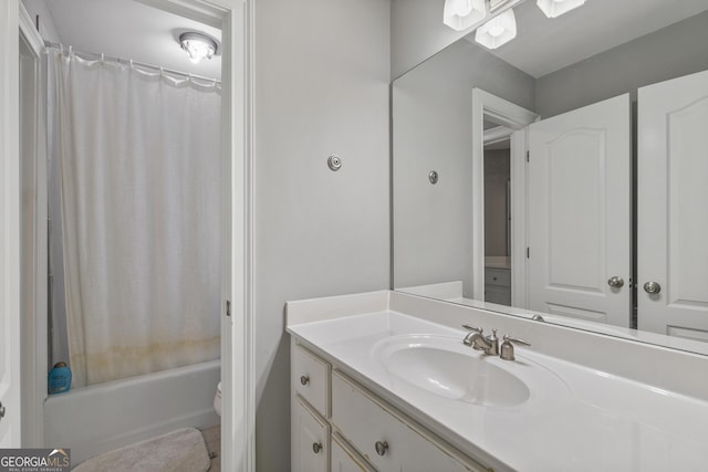 bathroom with vanity, shower / tub combo, and toilet