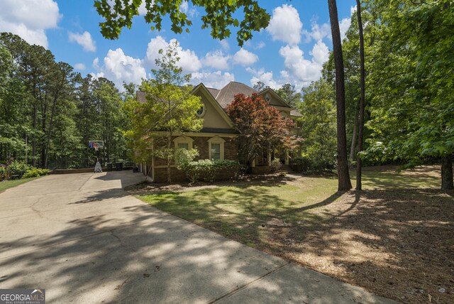 view of property exterior featuring stucco siding and brick siding