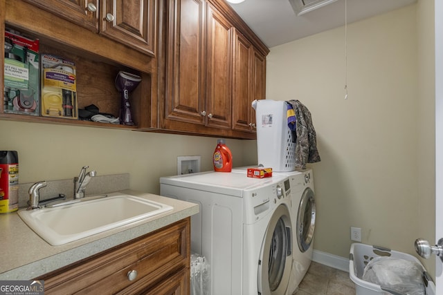 laundry area with cabinet space, a sink, separate washer and dryer, attic access, and light tile patterned floors