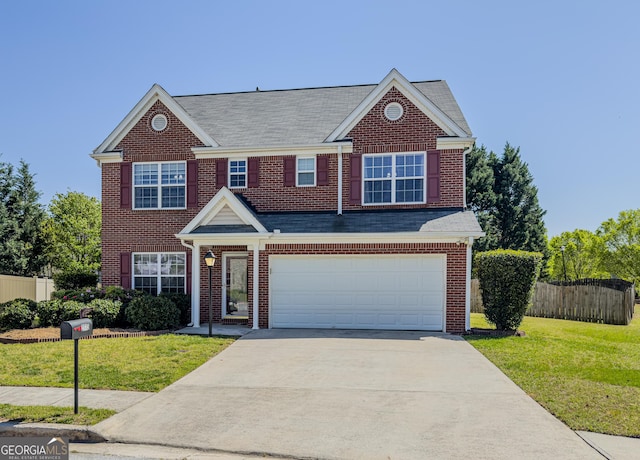 view of front facade with a front lawn, concrete driveway, fence, brick siding, and an attached garage