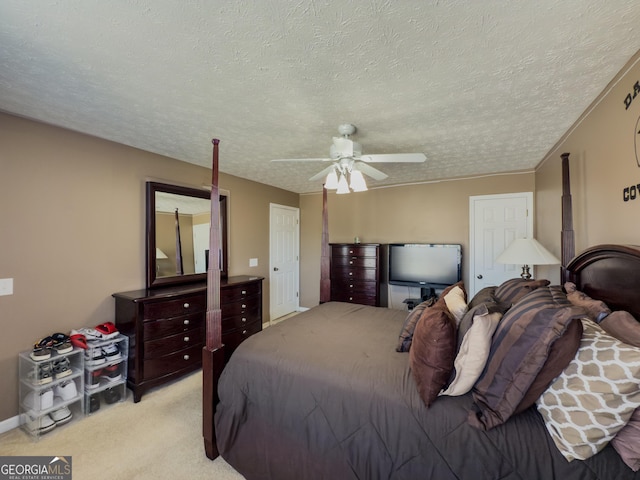 bedroom with light carpet, a textured ceiling, and ceiling fan
