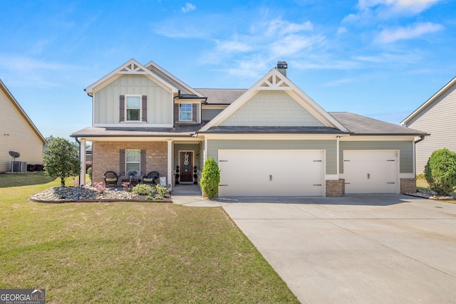 411 Conductor Ct, Jefferson, GA 30549 - craftsman inspired home featuring a garage, brick siding, a front lawn, and concrete driveway