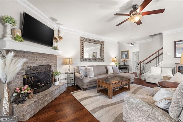 411 Conductor Ct, Jefferson, GA 30549 - living area with crown molding, a brick fireplace, a chandelier, and dark wood-style floors