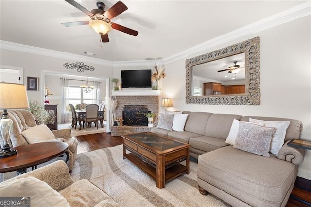 411 Conductor Ct, Jefferson, GA 30549 - living room featuring recessed lighting, dark wood-style floors, crown molding, a fireplace, and ceiling fan with notable chandelier