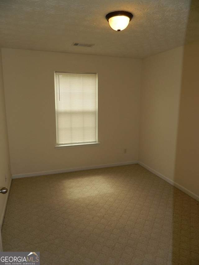 615 Magnolia Gardens Walk, Mcdonough, GA 30253 - empty room with visible vents, baseboards, carpet flooring, and a textured ceiling