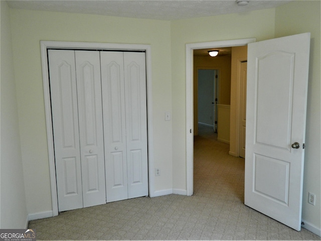 615 Magnolia Gardens Walk, Mcdonough, GA 30253 - unfurnished bedroom with light carpet, baseboards, and a closet