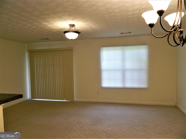 615 Magnolia Gardens Walk, Mcdonough, GA 30253 - unfurnished dining area with a textured ceiling, baseboards, carpet, and a notable chandelier