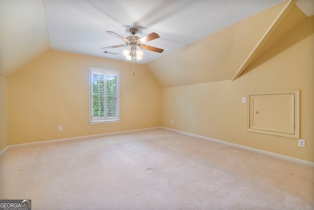 additional living space featuring a ceiling fan, light colored carpet, visible vents, and vaulted ceiling