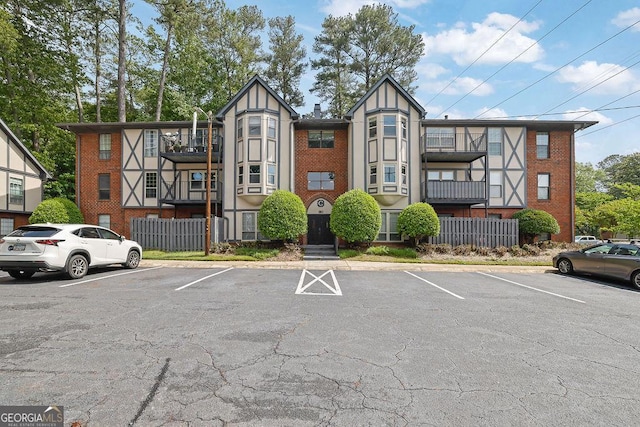 view of building exterior featuring uncovered parking